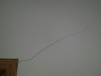 V shaped crack in wall